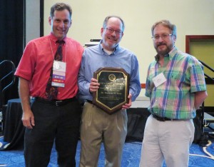 Dr. Theodore Klein (c) receiving the SIVB Fellow Award at the 2014 World Forum on Biology from John Finer (l) and Wayne Parrot (r)